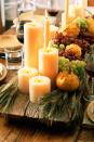 <p>Seasonal produce, sprigs of greenery, and white pillar candles of varying heights set off this rustic serving tray. Just remember to use unscented candles if they're going to be lit during dinner - aromatherapy can mess with your tastebuds! </p>