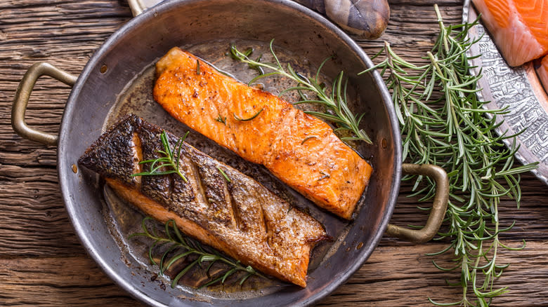 Scored seared salmon in pan