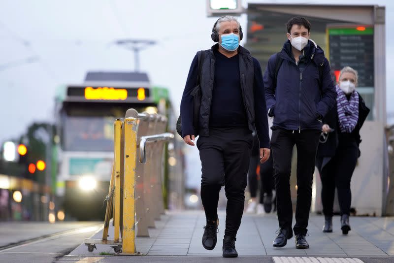 People wear face masks in Melbourne, the first city in Australia to enforce mask-wearing to curb a resurgence of COVID-19