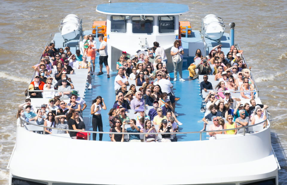 People travel by boat on the River Thames as temperatures remain high in London.