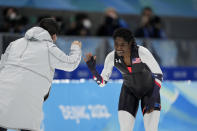 Erin Jackson of the United States reacts with coach Ryan Shimabukuro after winning the gold medal in the speedskating women's 500-meter race at the 2022 Winter Olympics, Sunday, Feb. 13, 2022, in Beijing. (AP Photo/Ashley Landis)