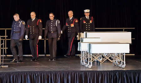 Halifax Regional Police and Fire Honour Guard walk off away after delivering the caskets of the Barho family children during a funeral service for the Syrian refugee family who lost seven children in a February 19 house fire in Halifax, Nova Scotia, Canada February 23, 2019. REUTERS/Ted Pritchard