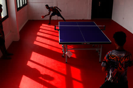 Papua New Guinea table tennis players Goada Elly and David Thomas play on a table during a practice session at a Beijing-funded facility in central Port Moresby in Papua New Guinea, November 19, 2018. REUTERS/David Gray