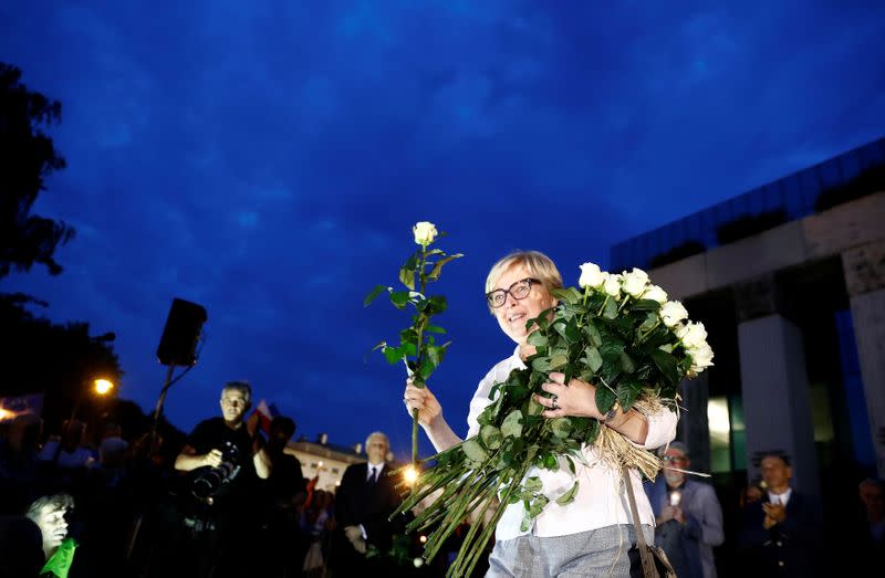 FILE PHOTO: Head of the Poland's Supreme Court Gersdorf gives flowers to protesters during a demonstration against judicial reforms in Warsaw