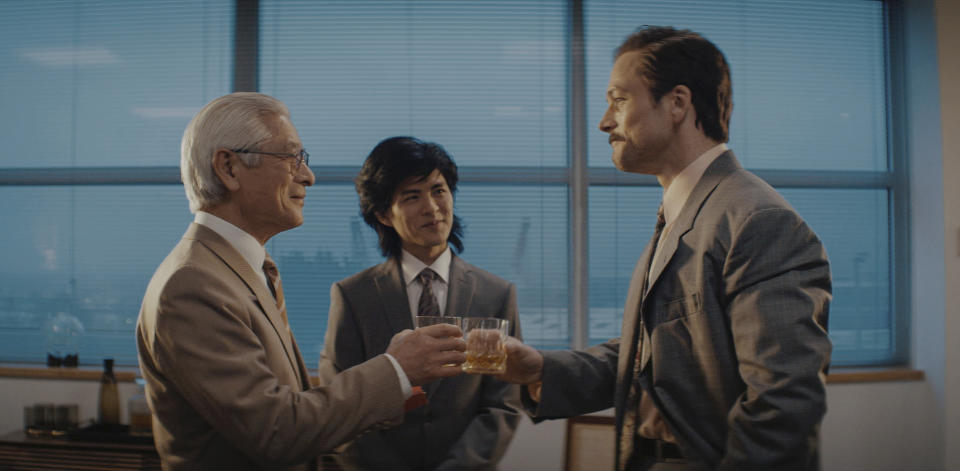 This image released by Apple TV+ shows Togo Igawa, from left, Nino Furuhata and Taron Egerton in a scene from "Tetris," premiering March 31, 2023. (Apple TV+ via AP)