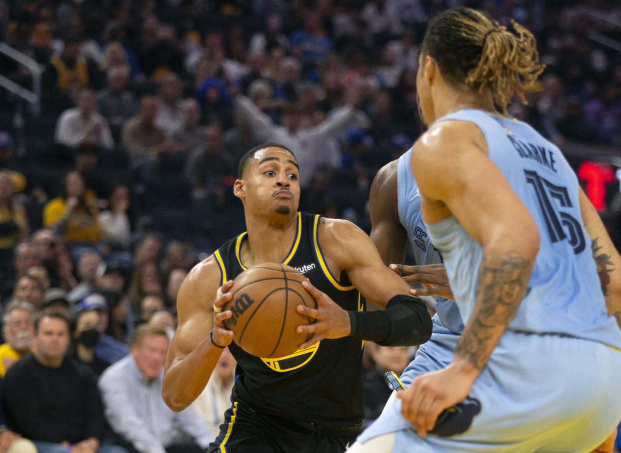 Golden State Warriors guard Jordan Poole drives between Memphis Grizzlies forwards Jaren Jackson Jr. and Brandon Clarke during Game 3 of the Western Conference semifinal series at Chase Center in San Francisco on May 7, 2022. (D. Ross Cameron/USA TODAY Sports)