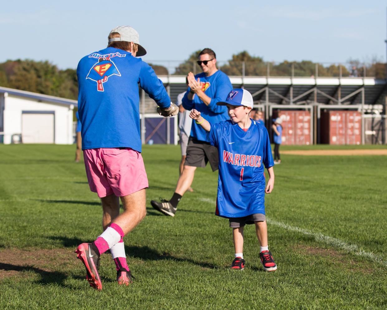 Winnacunnet goalie Tanyon Ziolkowski gives Evan Austin a fist bump after Evan scored a a ceremonial goal when he was honorary boys soccer captain last October. Winnacunnet boys soccer Nick Rowe applauds in the background. Austin passed away in June from the rare brain cancer diffuse intrinsic pontine glioma. The Winnacunnet boys and girls soccer teams will honor Austin during Friday's games against Exeter.