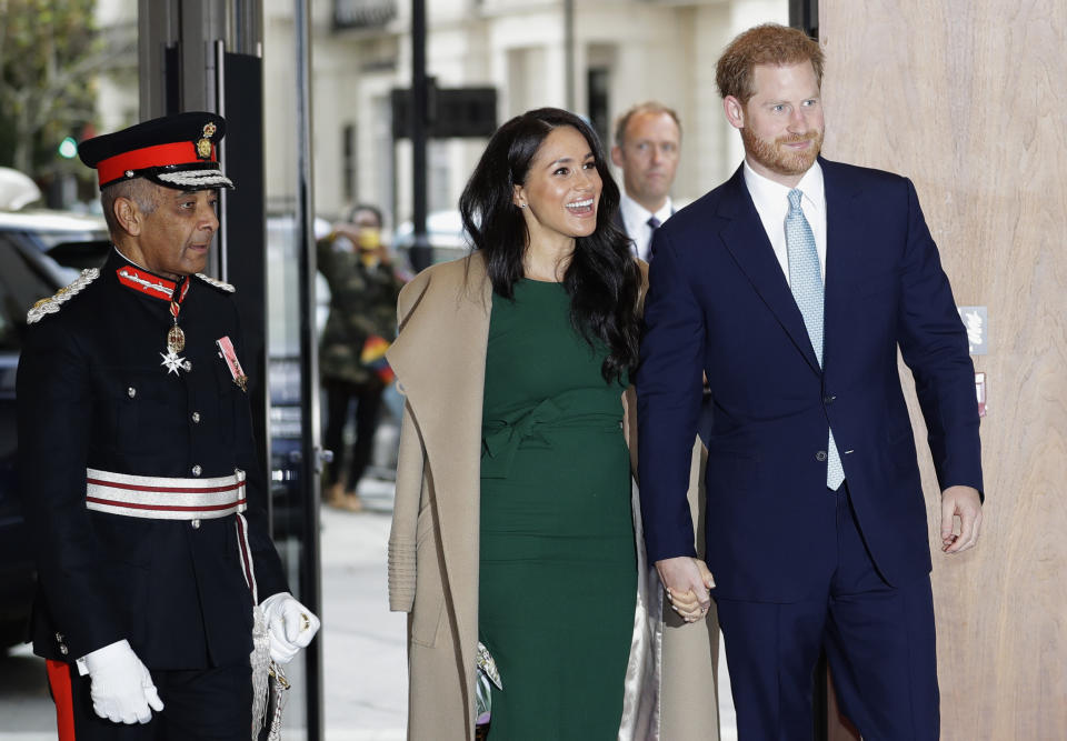 FILE - In this Tuesday, Oct. 15, 2019 file photo, Britain's Prince Harry and Meghan, the Duke and Duchess of Sussex arrive to attend the WellChild Awards Ceremony in London. In a stunning declaration, Britain’s Prince Harry and his wife, Meghan, said they are planning “to step back” as senior members of the royal family and “work to become financially independent.” A statement issued by the couple Wednesday, Jan. 8, 2020 also said they intend to “balance” their time between the U.K. and North America(AP Photo/Kirsty Wigglesworth, file)