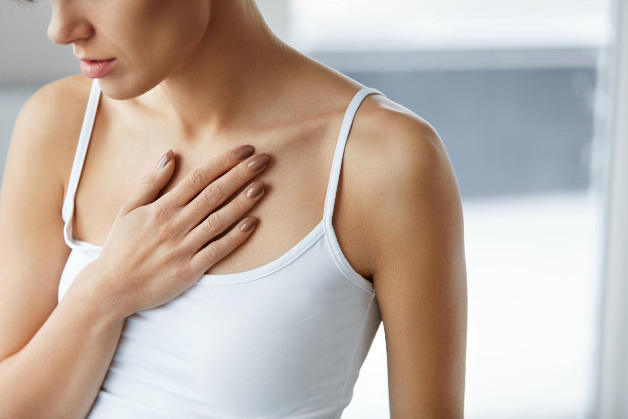 Heart Health Care. Closeup Of Young Woman Feeling Strong Pain In Chest. Close-up Of Female Body With Hand On Chest. Girl Suffering From Painful Feeling, Having Health Issues. High Resolution Image