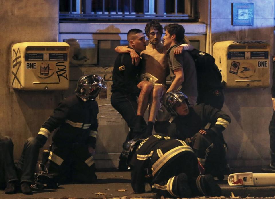 <div class="inline-image__caption"><p>French fire brigade members aid an injured individual near the Bataclan concert hall following fatal shootings in Paris, France, November 13, 2015.</p></div> <div class="inline-image__credit">Christian Hartmann/Reuters</div>