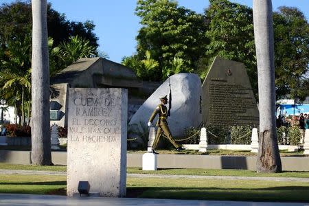 A guard marches near a granite boulder where Cuba's former President Fidel Castro's ashes were encased during a private ceremony at the Santa Ifigenia Cemetery, in Santiago de Cuba, December 4, 2016. REUTERS/Ivan Alvarado