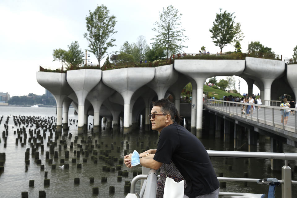 NEW YORK, NEW YORK - JULY 25: A man looks on with the Little Island in the background on Pier 55 as summer entertainment returns on July 25, 2021 in New York City. (Photo by John Lamparski/Getty Images)