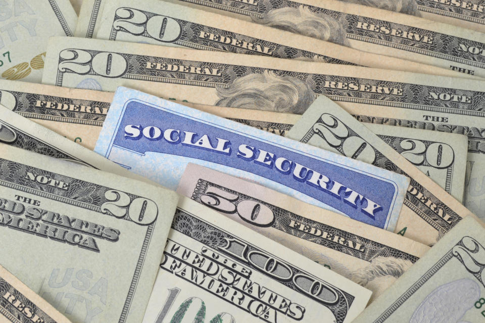 a Social Security card nestled among dollar bills
