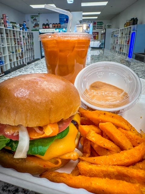 "The Classic" a vegan burger with red onion, lettuce, tomato, cheese, house-made chipotle pikliz. Top Notch Wellness Center located at 742 Crescent St., opened in November to give Brockton another vegan restaurant with miniature vegan market for all your vegan needs. Jan. 10, 2024.