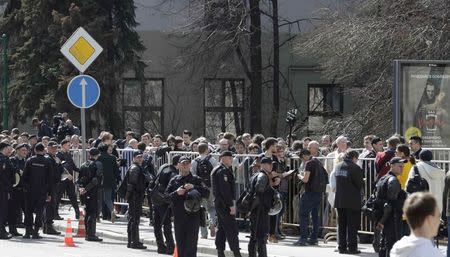 Interior Ministry officers maintain order as people stand in a queue to get to an office of the presidential administration during an opposition protest, calling for Russian President Vladimir Putin not to run for another presidential term next year, in Moscow, Russia, April 29, 2017. REUTERS/Tatyana Makeyeva