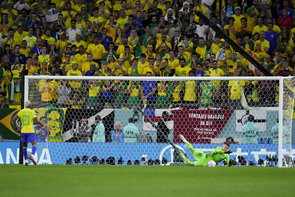 Croatia's goalkeeper Dominik Livakovic stops a penalty kick from Brazil's Vinicius Junior during the penalty shootout in the World Cup quarterfinal soccer match between Croatia and Brazil, at the Education City Stadium in Al Rayyan, Qatar, Friday, Dec. 9, 2022. (AP Photo/Manu Fernandez)