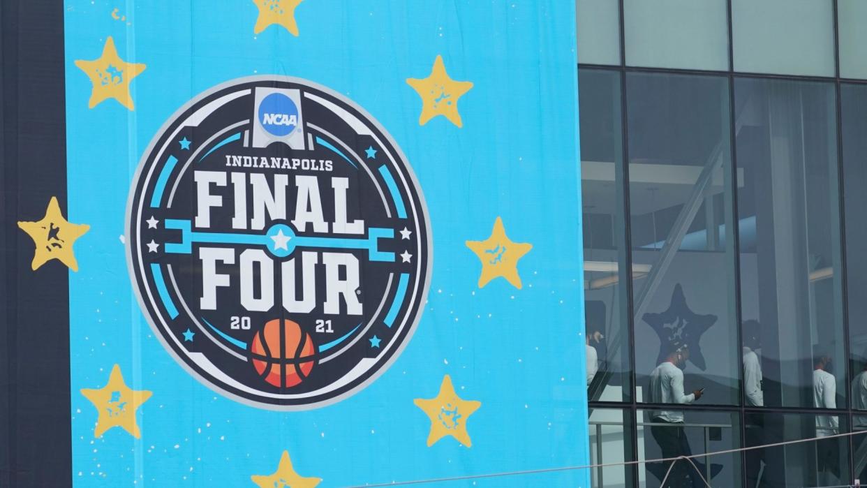 Mandatory Credit: Photo by Darron Cummings/AP/Shutterstock (11804196l)Basketball team walks through a crosswalk to the Indiana Convention Center for the NCAA college basketball tournament, in IndianapolisNCAA Tournament Fans Basketball, Indianapolis, United States - 17 Mar 2021.