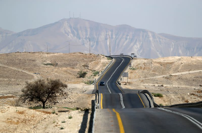 FILE PHOTO: Vehicles drive through a road in Jordan Valley, the eastern-most part of the Israeli-occupied West Bank that borders Jordan