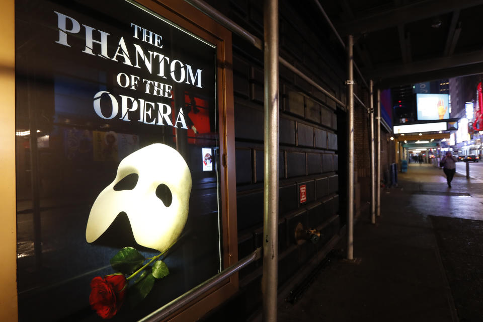 FILE - A poster advertising "The Phantom of the Opera," is displayed on the shuttered Majestic Theatre in New York, March 12, 2020. Broadway's longest-running show will play its final performance on Broadway on Feb. 18, 2023, a spokesperson told The Associated Press on Friday, Sept. 16, 2022. The closing will come less than a month after its 35th anniversary. (AP Photo/Kathy Willens, File)