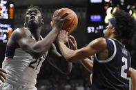 Connecticut's Adama Sanogo goes up to the basket as Georgetown's Dante Harris (2) defends in the second half of an NCAA college basketball game, Tuesday, Jan. 25, 2022, in Storrs, Conn. (AP Photo/Jessica Hill)