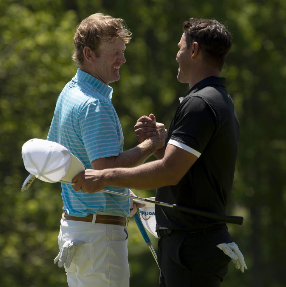 Brandt Snedeker, left, is congratulated by Brooks Koepka as their group finishes the second round of the Canadian Open golf tournament in Ancaster, Ontario, Friday, June 7, 2019. (Adrian Wyld/The Canadian Press via AP)