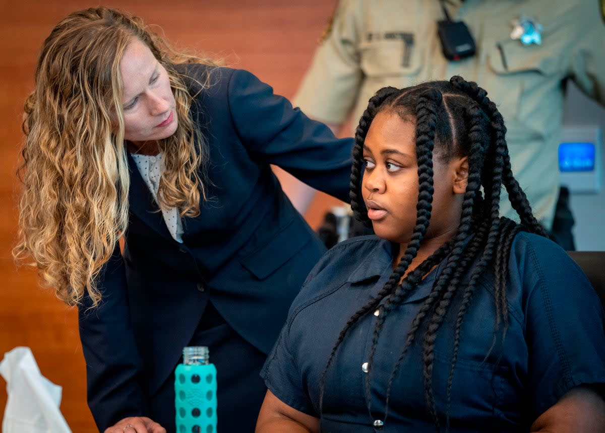 Pieper Lewis, right, speaks with attorney Magdalena Reese (AP)