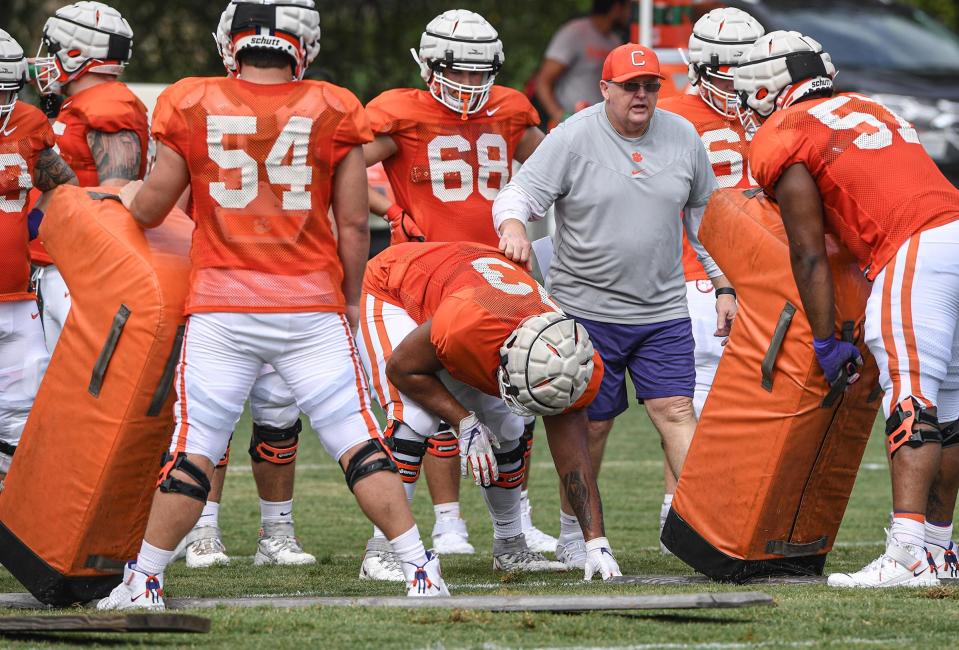 Clemson offensive line coach Robbie Caldwell works with his guys during preseason.