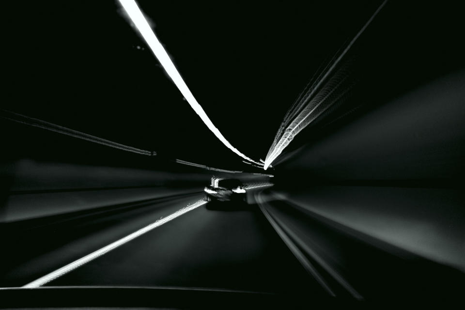 Motion blur driving through a tunnel black and white