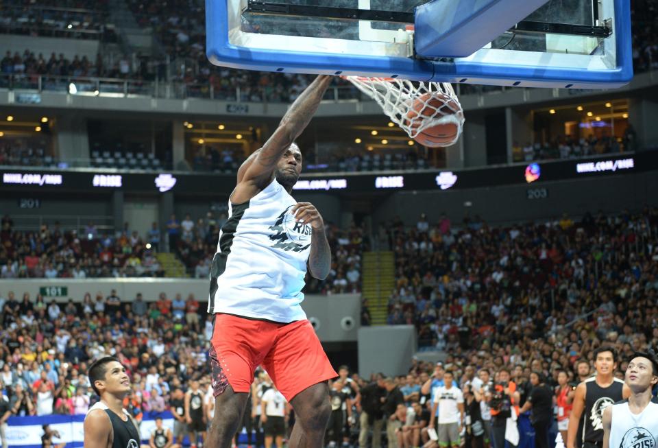 US NBA superstar LeBron James plays during an exhibition game as part of a clinic session in Manila on August 20, 2015. James is here to conduct basketball clinic to select talented baskeball players from disadvantaged families.    AFP PHOTO / TED ALJIBE        (Photo credit should read TED ALJIBE/AFP/Getty Images)