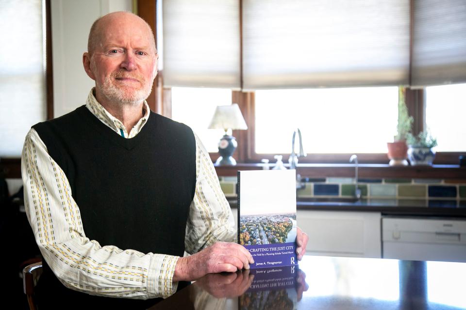 Jim Throgmorton, former Iowa City mayor, poses in April with his new book, "Co-crafting the Just City." Throgmorton will be speaking about the idea at the Iowa City Book Festival.