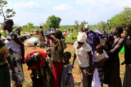 South Sudanese families queues for vaccination in Lamwo after fleeing fighting in Pajok town across the border in northern Uganda April 5, 2017. REUTERS/James Akena