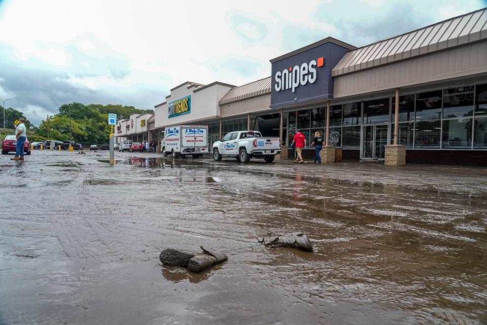 Stores clean up after massive Providence floods.