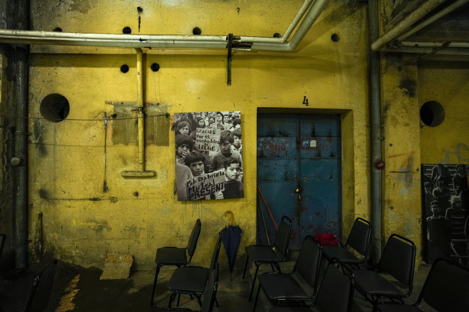 A poster that shows children thanking President Salvador Allende for his free milk program, adorns a dressing room in the National Stadium that was used as a prison and place of torture during the Augusto Pinochet dictatorship, in Santiago, Chile, Saturday, Aug. 19, 2023. After a military coup deposed of Allende on September 11, 1973, Chilean Cardinal Raúl Silva Henríquez led efforts to create a committee that provided spiritual, judicial and financial support for the victims of the Pinochet regime until it was dissolved due to government pressure in 1975. Immediately after, Silva Henríquez established the Vicariate of Solidarity. (AP Photo/Esteban Felix)