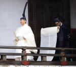 Japan's Emperor Naruhito, in a white robe, visits “Kashikodokoro”, a shrine at the Imperial Palace, in Tokyo, Tuesday, Oct. 22, 2019. Emperor Naruhito visited three Shinto shrines at the palace before proclaiming himself Japan’s 126th emperor in an enthronement ceremony. (Kyodo News via AP)