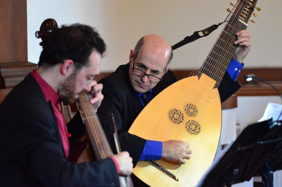 William Simms, right, plays the  theorbo.