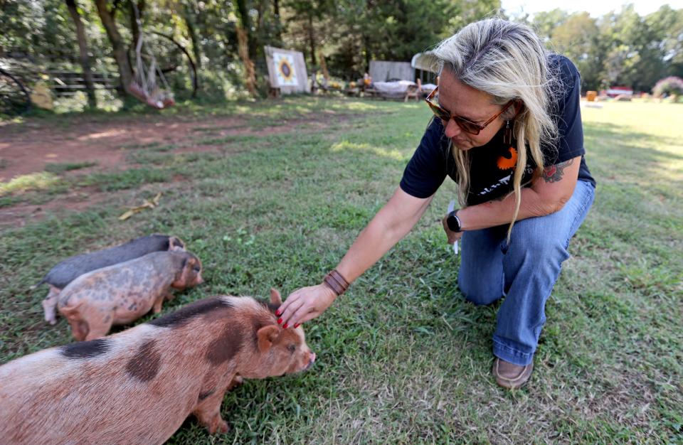 Honnie Dudley, Parkhurst Ranch general manager, pets pigs at the Parkhurst Pumpkin Patch in Arcadia.
