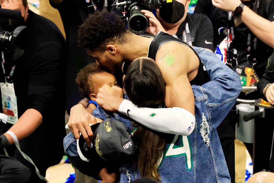 Giannis Antetokounmpo #34 of the Milwaukee Bucks celebrates with his family after defeating the Phoenix Suns