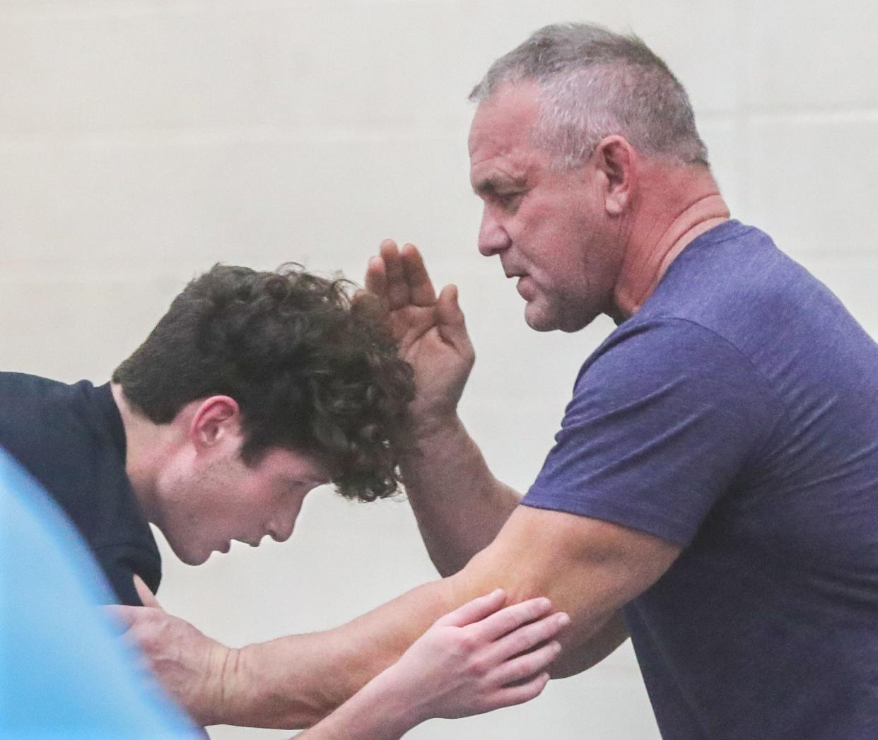 Streetsboro wrestling coach Mark Skonieczny works with Jacob Joltin at practice on Wednesday, Dec. 13, 2023.