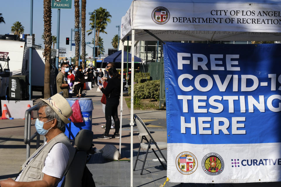 People wait in line to be tested for COVID-19 at a testing site in the North Hollywood section of Los Angeles on Saturday, Dec. 5, 2020. With coronavirus cases surging at a record pace, California Gov. Gavin Newsom announced a new stay-at-home order and said if people don't comply the state's hospitals will be overwhelmed with infected patients.(AP Photo/Richard Vogel)