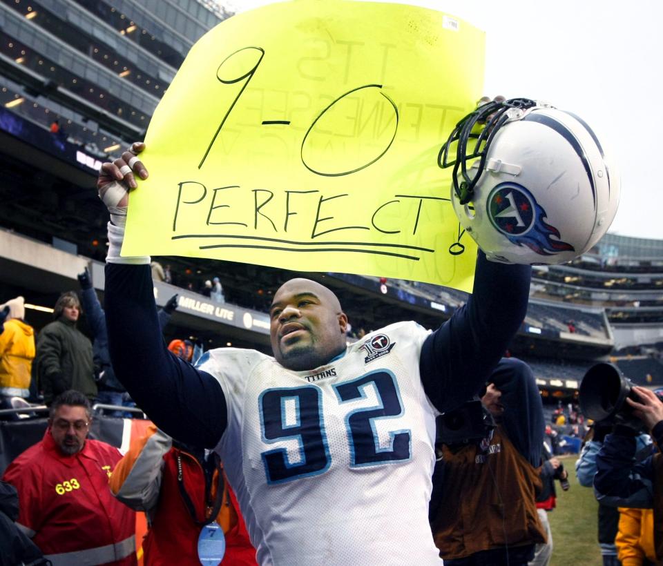 Tennessee Titans defensive tackle Haynesworth (92) carries a sign announcing the team's 9-0 record after defeating the Chicago Bears 21-14 at Soldier Field in Chicago Nov. 9, 2008. Haynesworth, a former University of Tennessee star, will participate in the April 20 clinic, part of the NFL Alumni's "Gear up Tennessee" initiative which promotes vaccinations and healthy lifestyle choices.