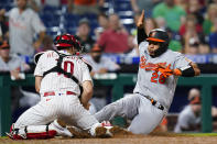 Baltimore Orioles' Pedro Severino, right, is tagged out at home by Philadelphia Phillies catcher J.T. Realmuto after trying to score on a single by Pat Valaika during the eighth inning of an interleague baseball game, Wednesday, Sept. 22, 2021, in Philadelphia. (AP Photo/Matt Slocum)