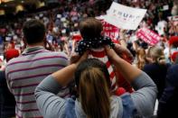 A woman holds up her baby in the crowd as U.S. President Donald Trump holds a rally with supporters in an arena in Youngstown, Ohio, U.S. July 25, 2017. REUTERS/Jonathan Ernst