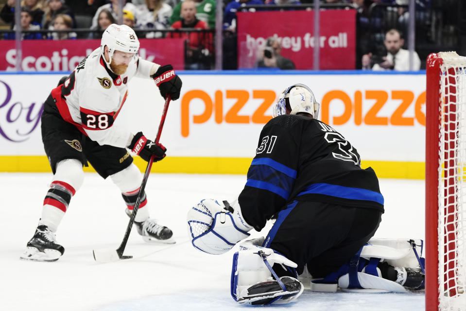 Toronto Maple Leafs goaltender Martin Jones (31) poke-checks Ottawa Senators' Claude Giroux (28) during the first period of an NHL hockey game, Wednesday, Dec. 27, 2023 in Toronto. (Frank Gunn/The Canadian Press via AP)