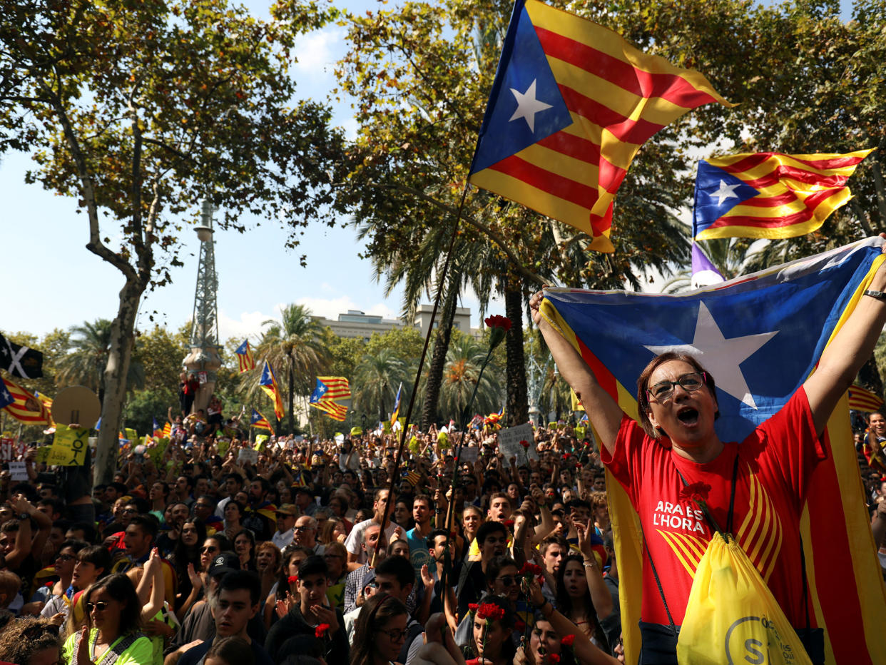 Protesters shout slogans and wave Esteladas (Catalan separatist flags) as they gather outside the High Court of Justice of Catalonia in Barcelona, Spain, on 21 September: Reuters