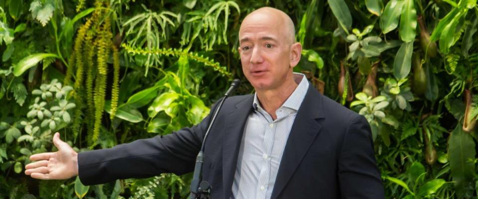 Jeff Bezos extends arm while talking at Amazon Spheres Grand Opening.