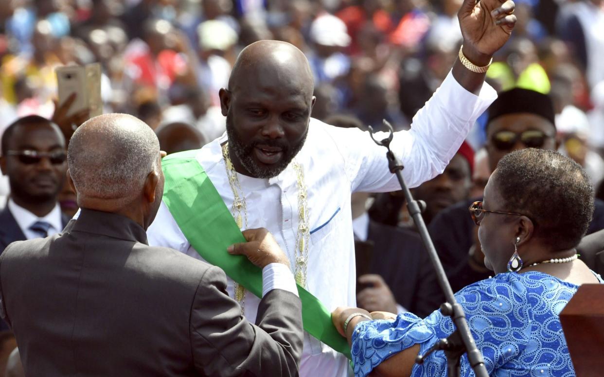 George Weah, the former football star, is sworn in as president of Liberia in front of thousands of adoring fans - AFP