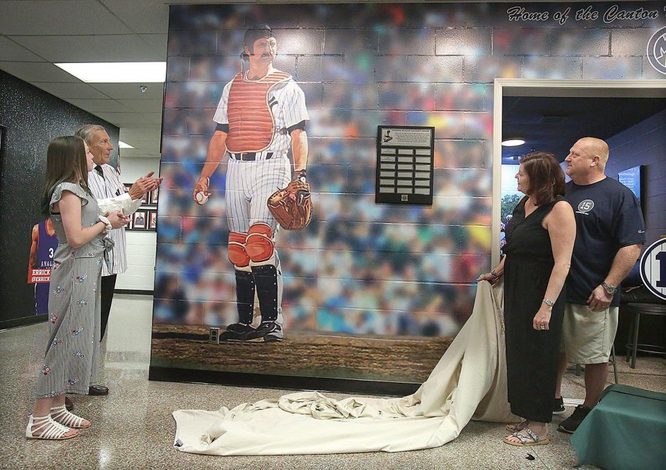 A Thurman Munson mural is unveiled at the J. Babe Stearn Community Center in 2020 by (from left) by Bella Munson, Canton Mayor Tom Bernabei, Michelle Munson and Mike Munson.