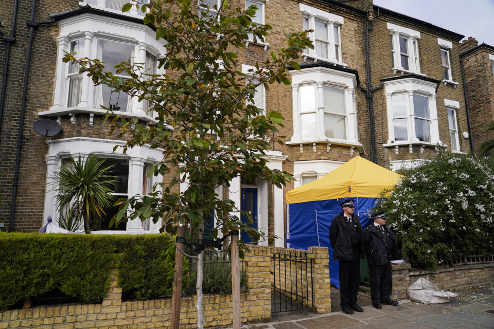 Police officers stand outside a house in north London, thought to be in relation to the death of Conservative MP Sir David Amess, Sunday, Oct. 17, 2021. Leaders from across Britain's political spectrum have come together to pay tribute to a long-serving British lawmaker who was stabbed to death in what police have described as a terrorist attack. (AP Photo/Alberto Pezzali)