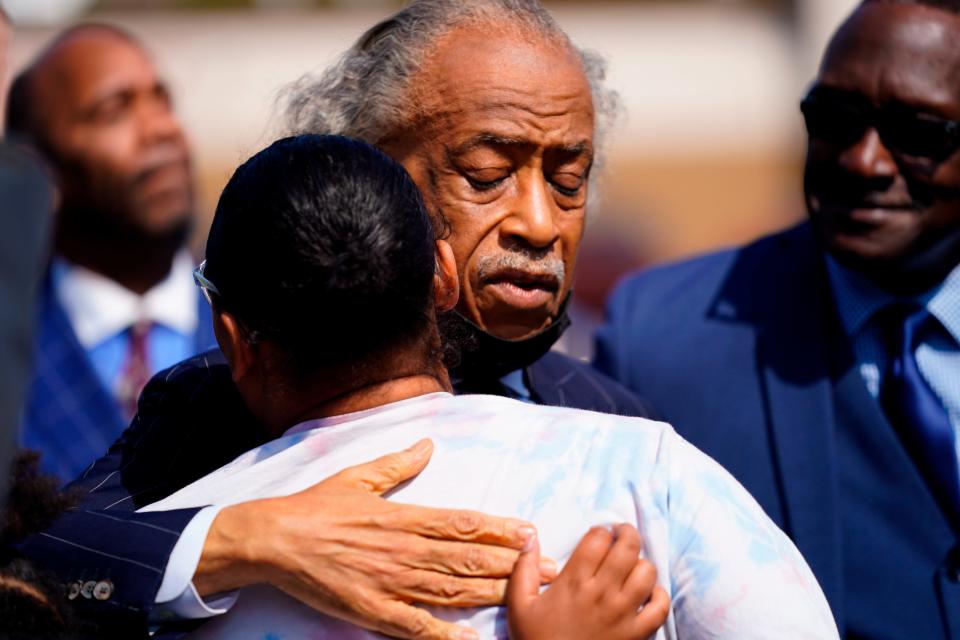 The Rev. Al Sharpton embraces a person during his visit on May 19, 2022, to the scene of a supermarket shooting in Buffalo, New York.