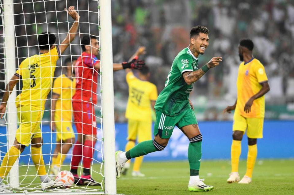 Roberto Firmino celebrates one goal of his hat-trick during Al-Ahli’s 3-1 victory over Al-Hazm in the opening game of the 2023-24 Saudi Pro League.